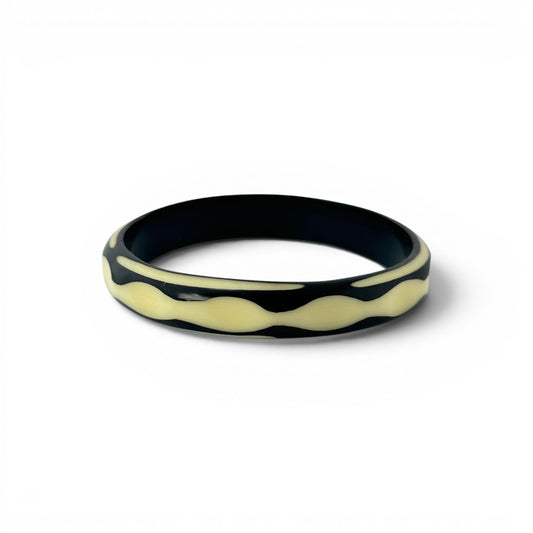 Hand-carved two-tone Bakelite bangle — angled view