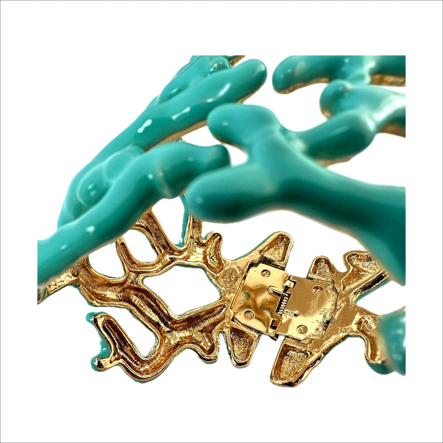 Kenneth Jay Lane coral cuff — macro of hinge area and KENNETH © LANE mark