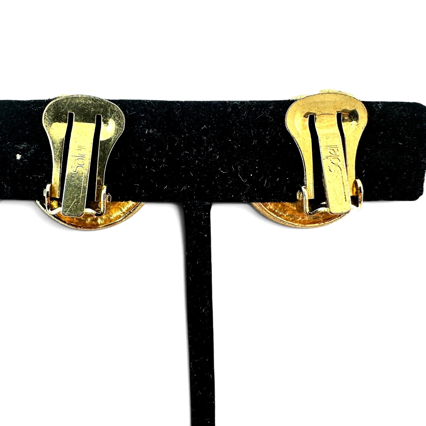 Front view of both Soleil gold-tone swirl earrings side by side showing circular form and high-shine polished surface