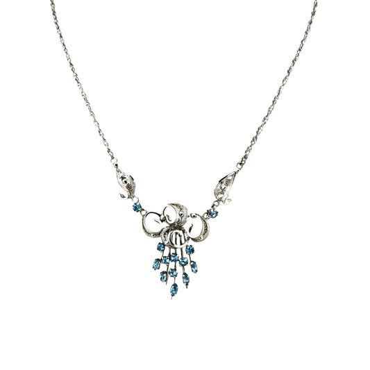 Scrollwork cannetille centerpiece with radiating pin-style aquamarine drops and torpedo spacer links, front view