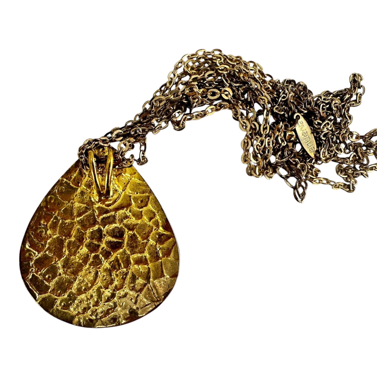 Close-up of Avenue branded oval hang tag stamped on aged gold-tone cable link chain near lobster clasp
