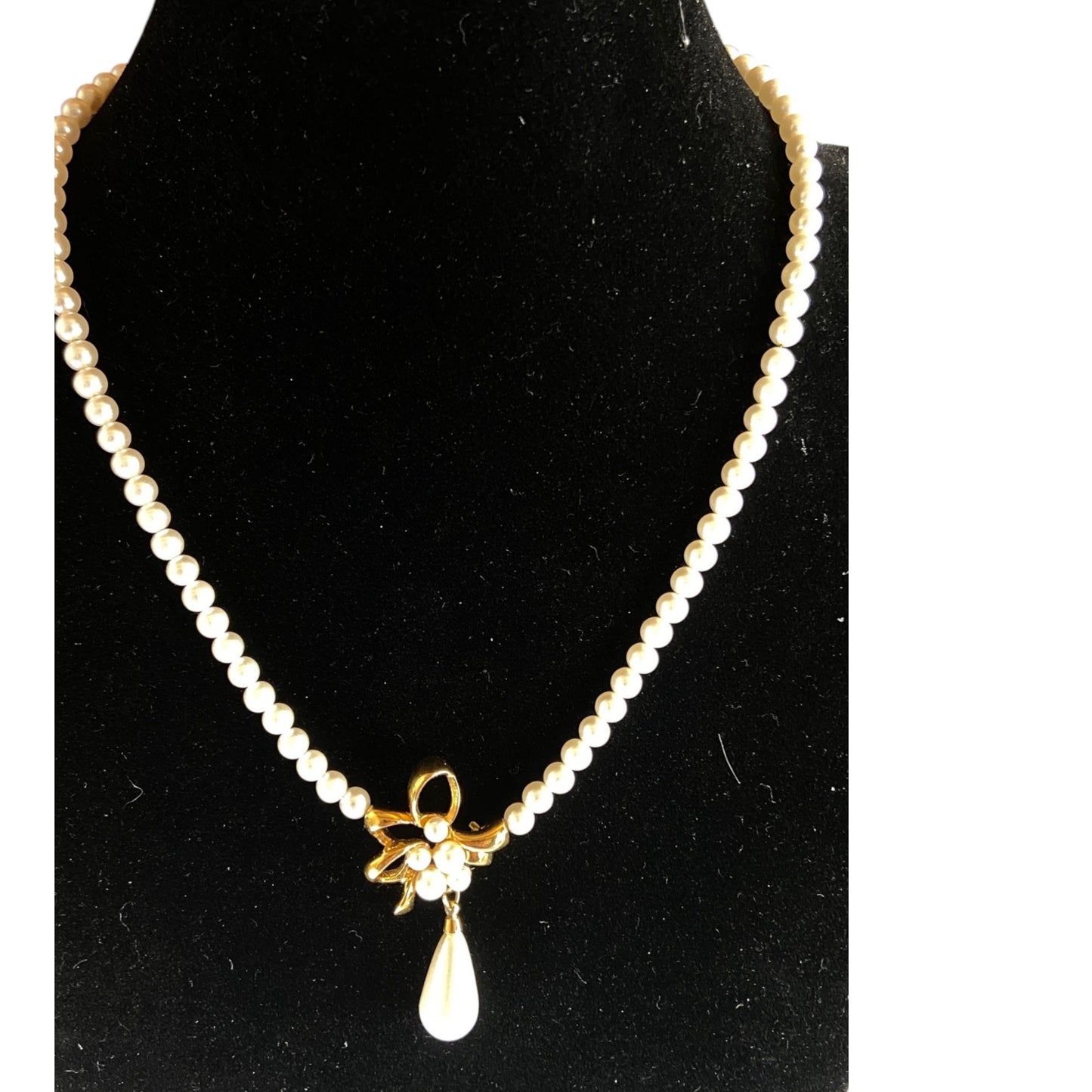 Napier single-strand faux pearl necklace with gold-tone bow centerpiece and teardrop pearl drop, cream and gold-tone