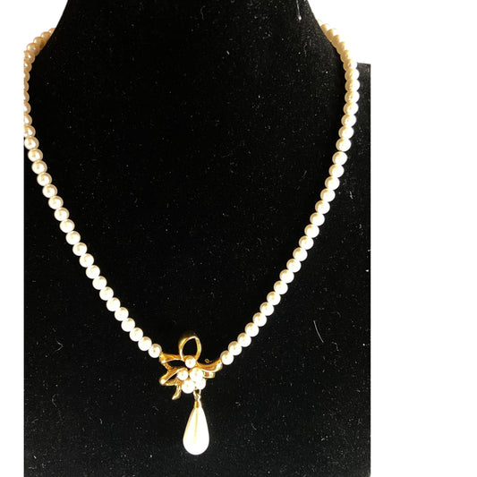 Napier single-strand faux pearl necklace with gold-tone bow centerpiece and teardrop pearl drop, cream and gold-tone