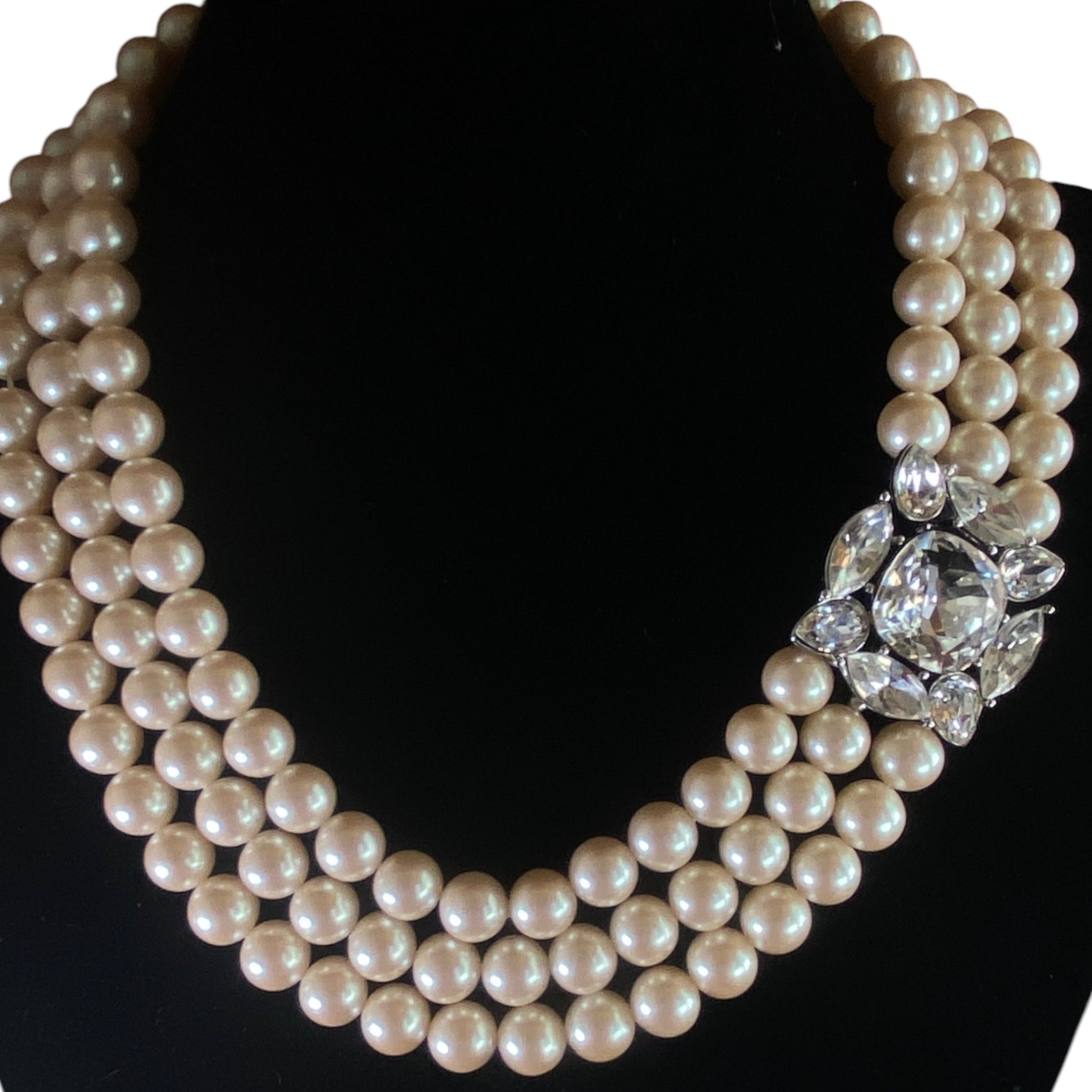 Monet three-strand cream faux pearl necklace with silver-tone crystal cushion and marquise side clasp, front view
