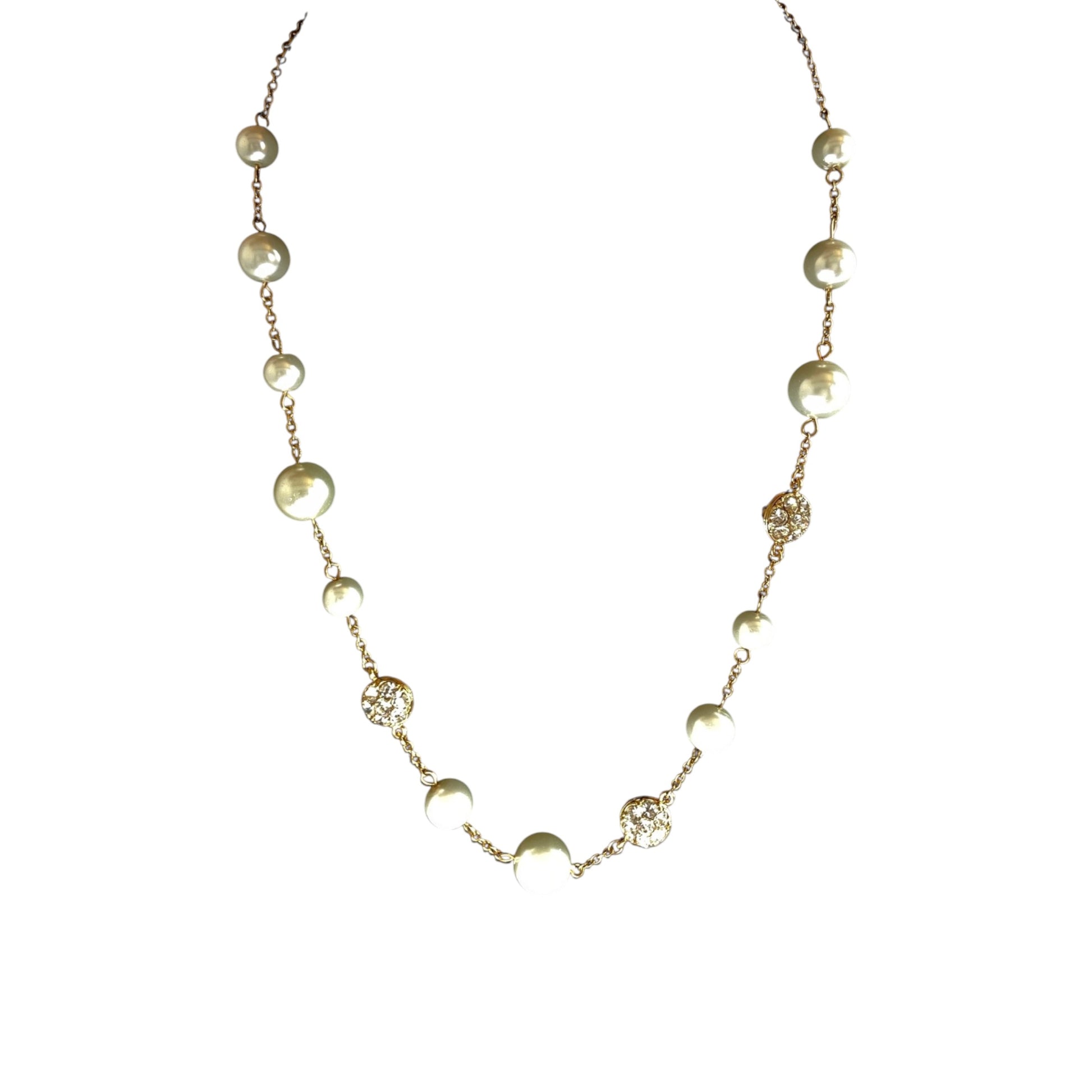 Gold-tone station necklace with alternating cream faux pearl beads and small pavé rhinestone disc links on fine cable chain