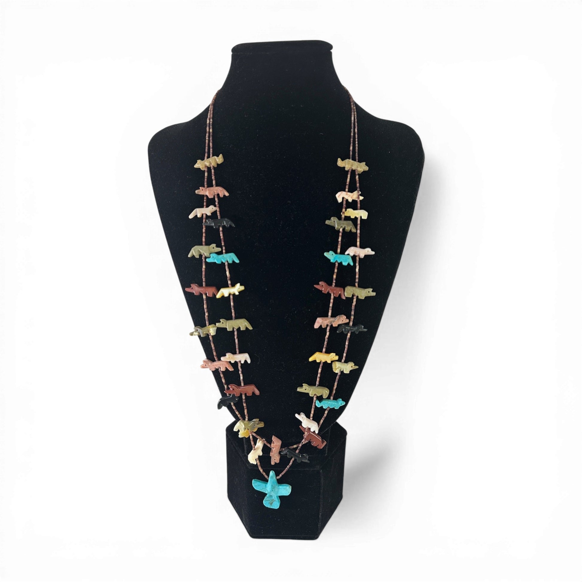 Two-strand heishi shell fetish necklace with hand-carved stone animal figurines strung laterally across both strands and a...