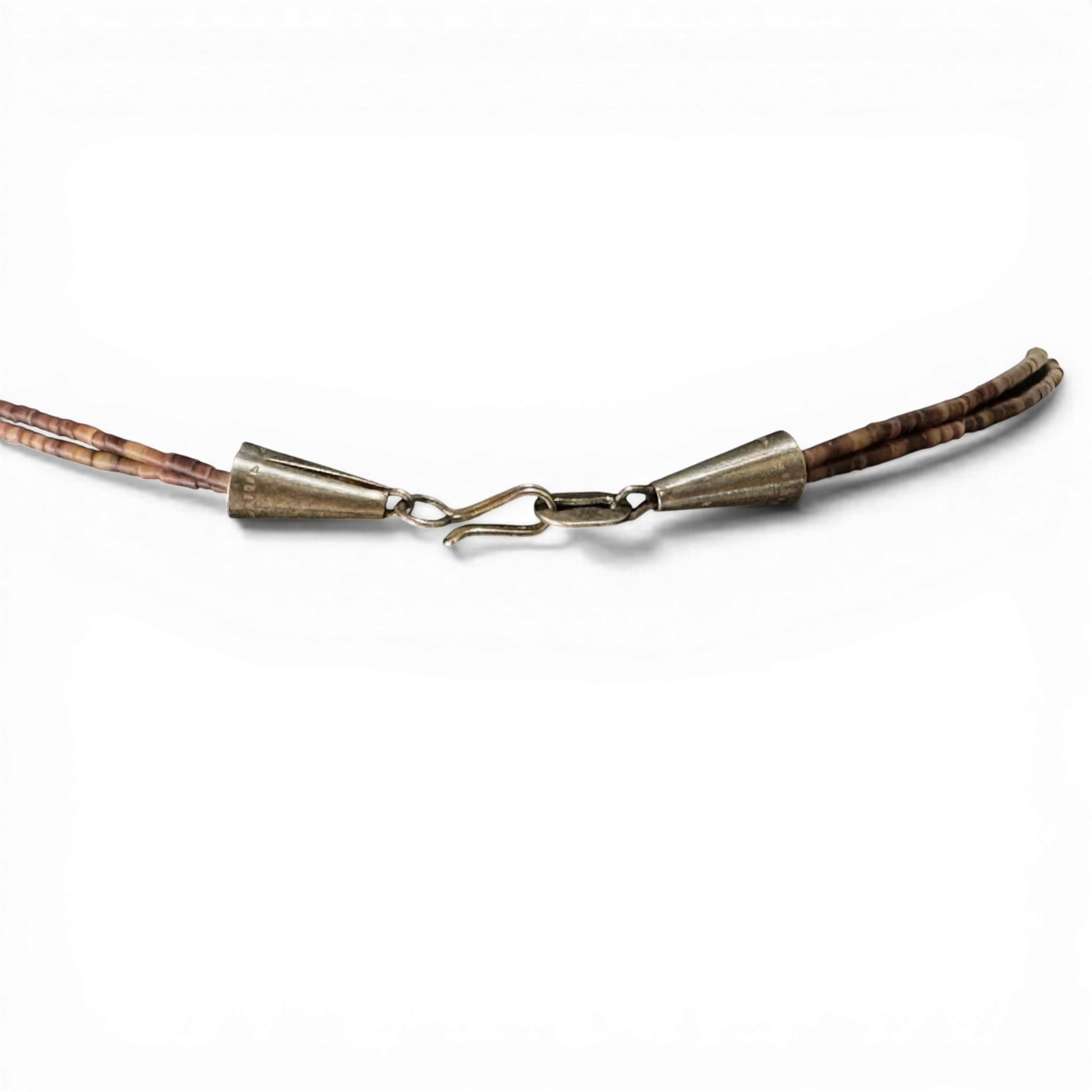 Silver-tone cone end caps and S-hook clasp closure detail on two-strand heishi fetish necklace