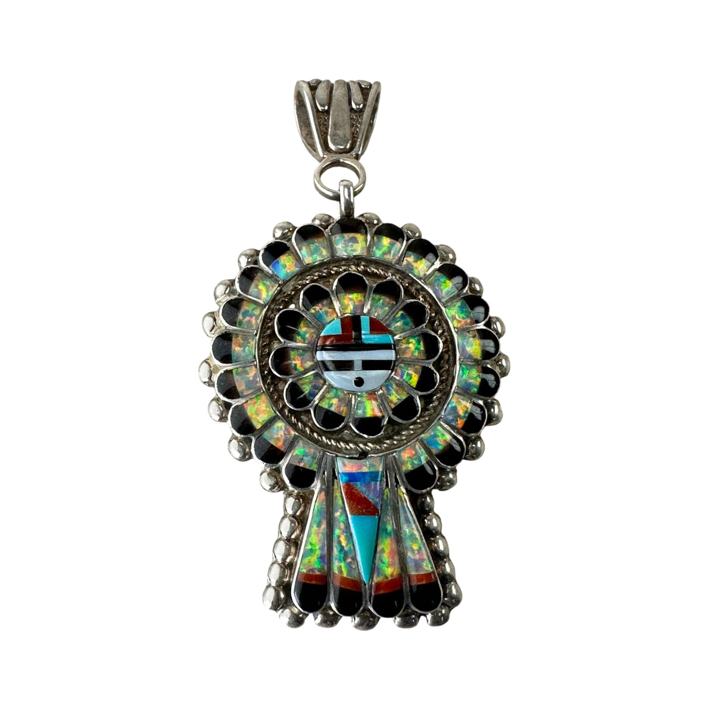 Close-up of Zuni-style Sun Face center with mosaic inlay face motif and radiating petal surround in opal and turquoise