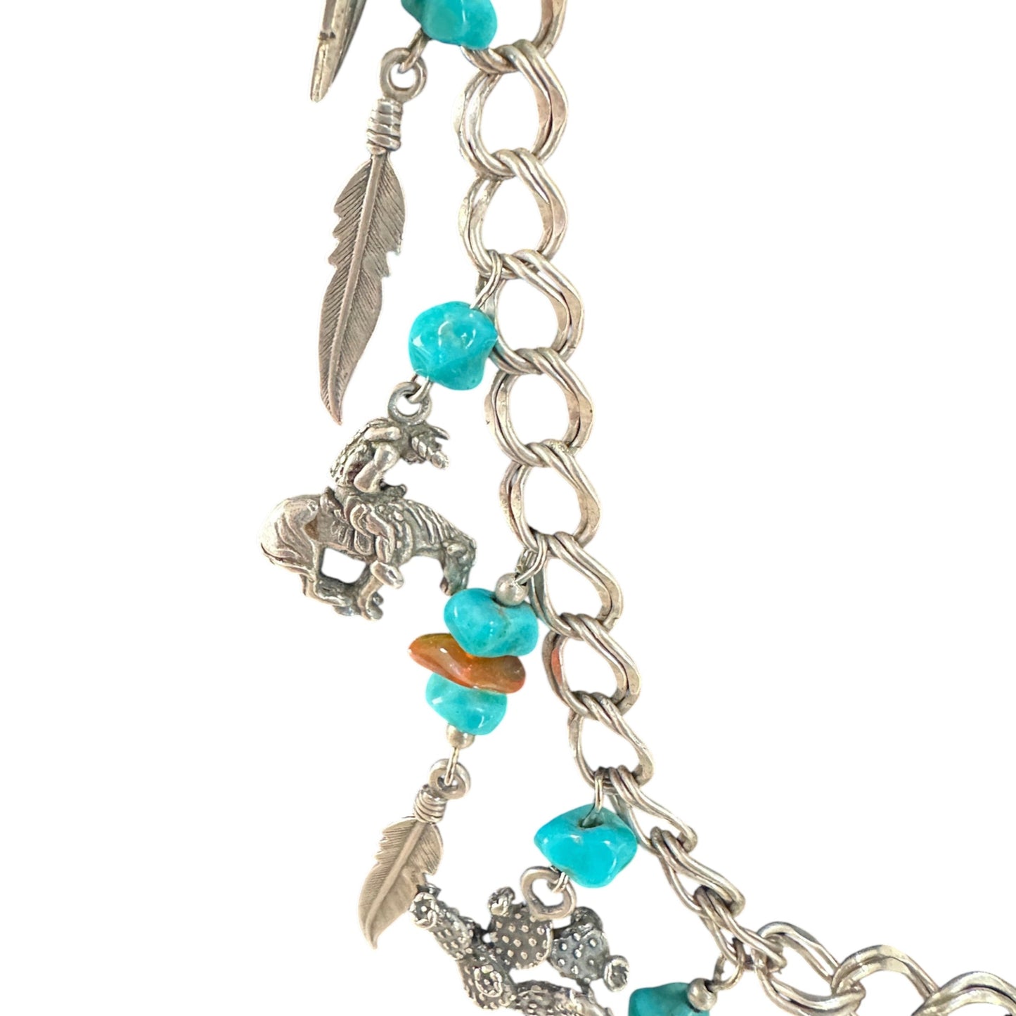 Detail of double curb-link sterling silver chain with figure-eight connector links, jump ring charm attachments, and natur...