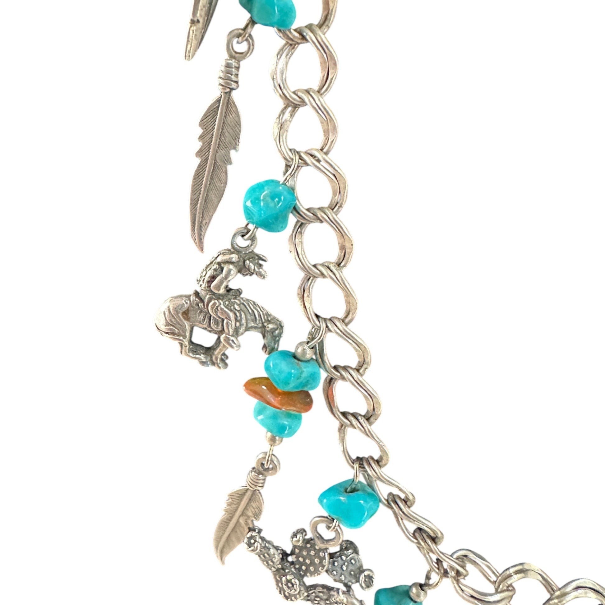 Detail of double curb-link sterling silver chain with figure-eight connector links, jump ring charm attachments, and natur...