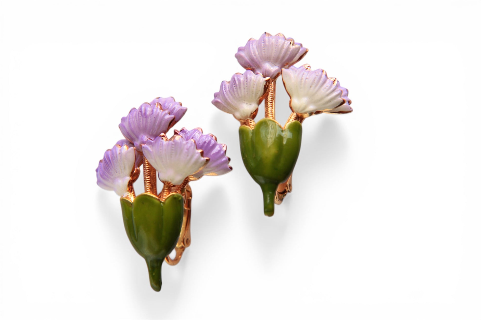 Pair of lavender and white enamel carnation clip-on earrings with tiered scalloped petals on a ridged gold-tone stem, fron...
