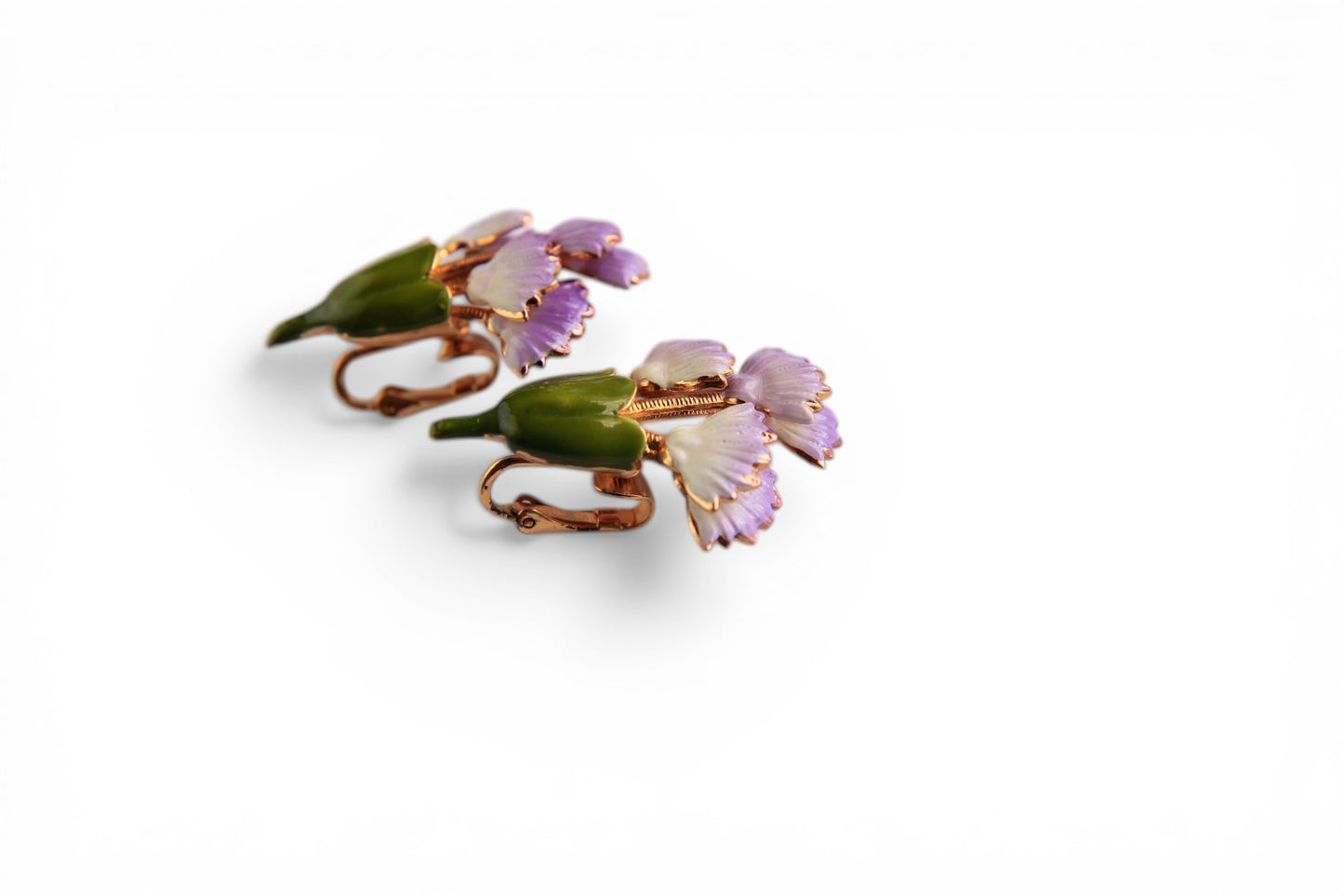 Three-dimensional molded green enamel calyx bud at the base of each floral clip-on earring