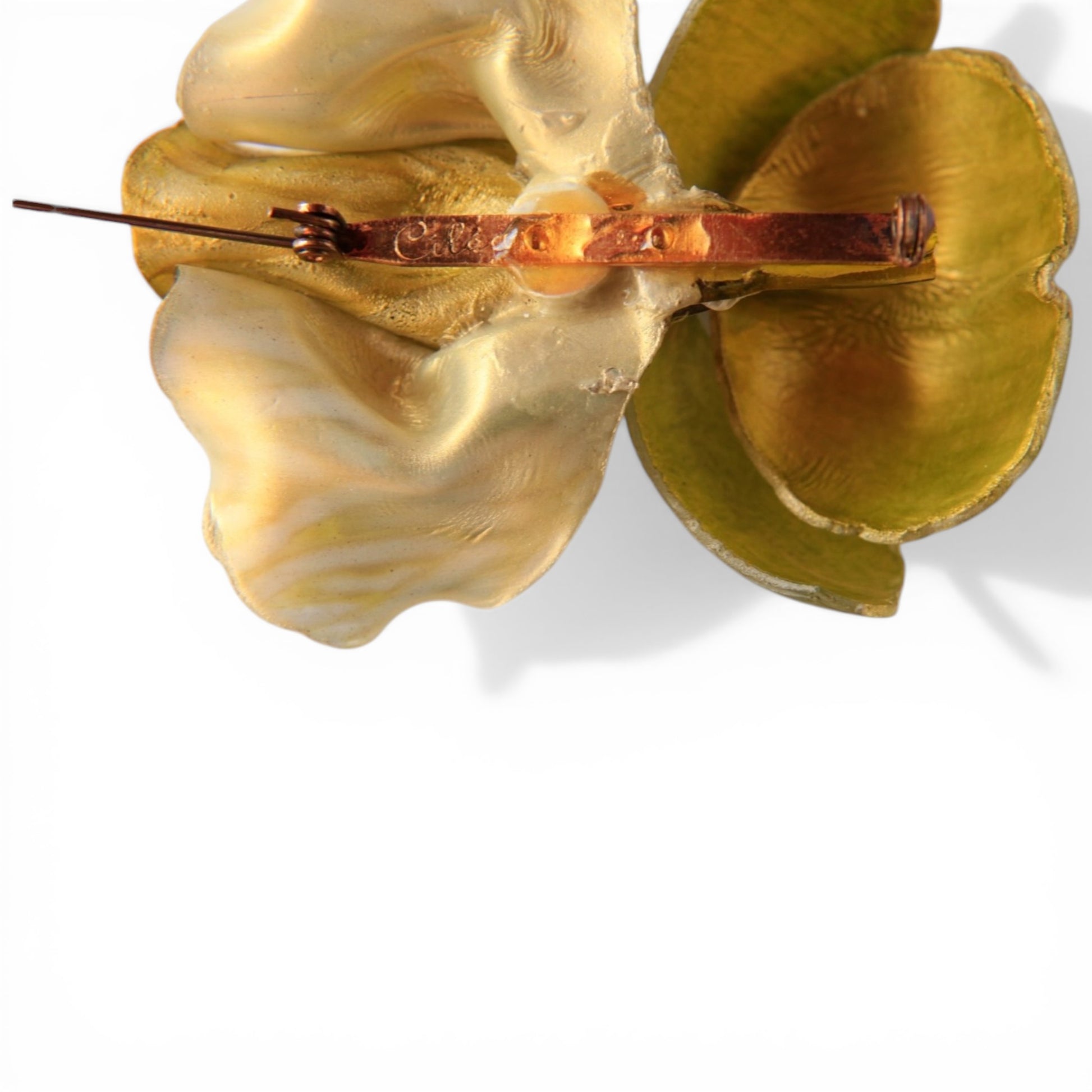 Reverse of Cilea iris brooch showing matte gilt metal back copper pin stem coiled wire hinge and C-catch with Cilea signat...