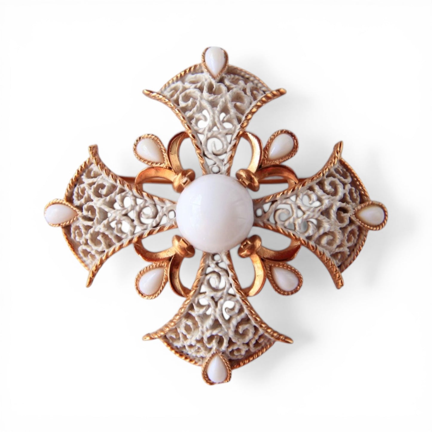 Trifari Maltese cross brooch in gold-tone with white enamel scroll filigree arms and nine milk glass cabochon stones, fron...