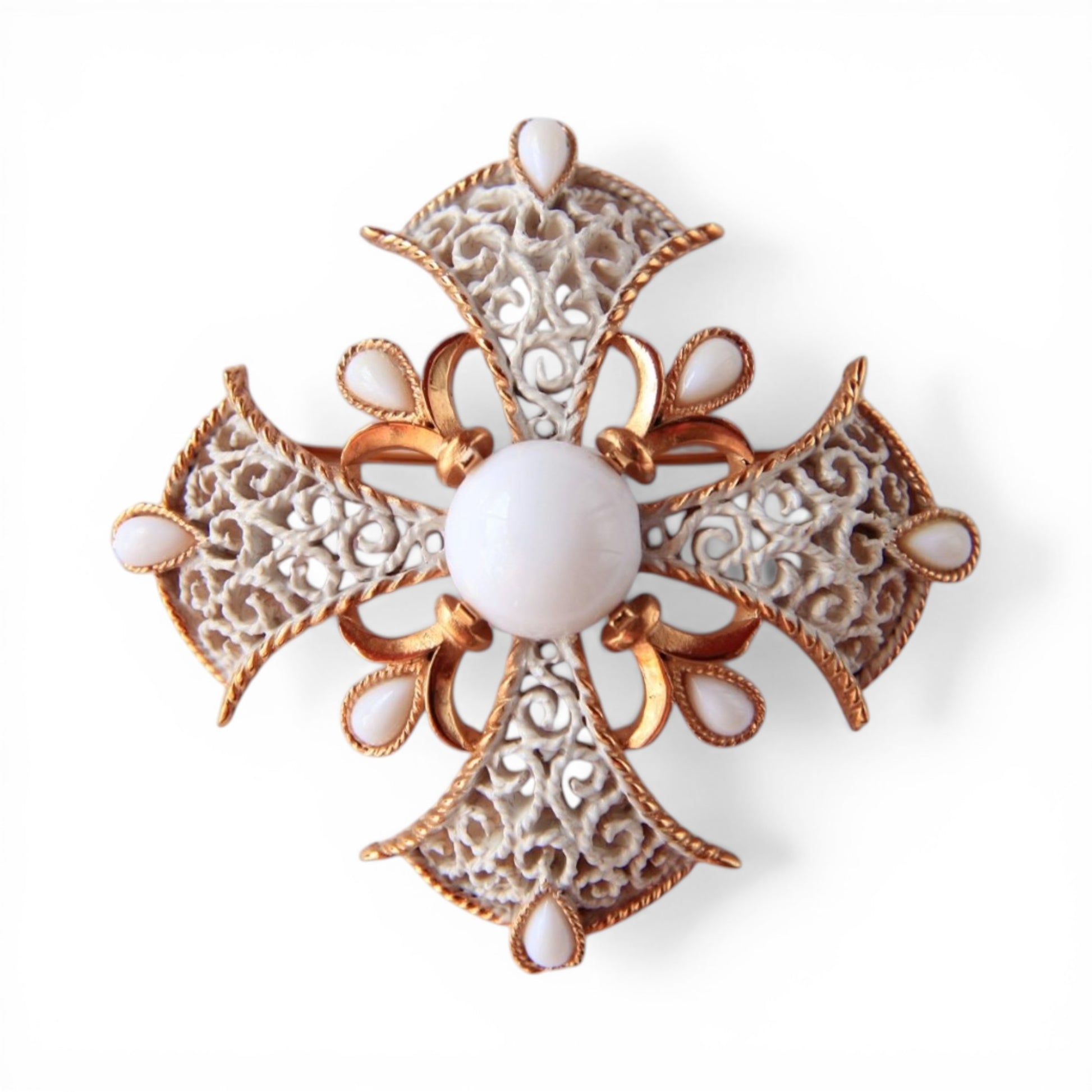 Trifari Maltese cross brooch in gold-tone with white enamel scroll filigree arms and nine milk glass cabochon stones, fron...