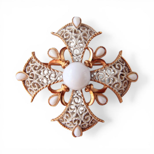 Trifari Maltese cross brooch in gold-tone with white enamel scroll filigree arms and nine milk glass cabochon stones, fron...