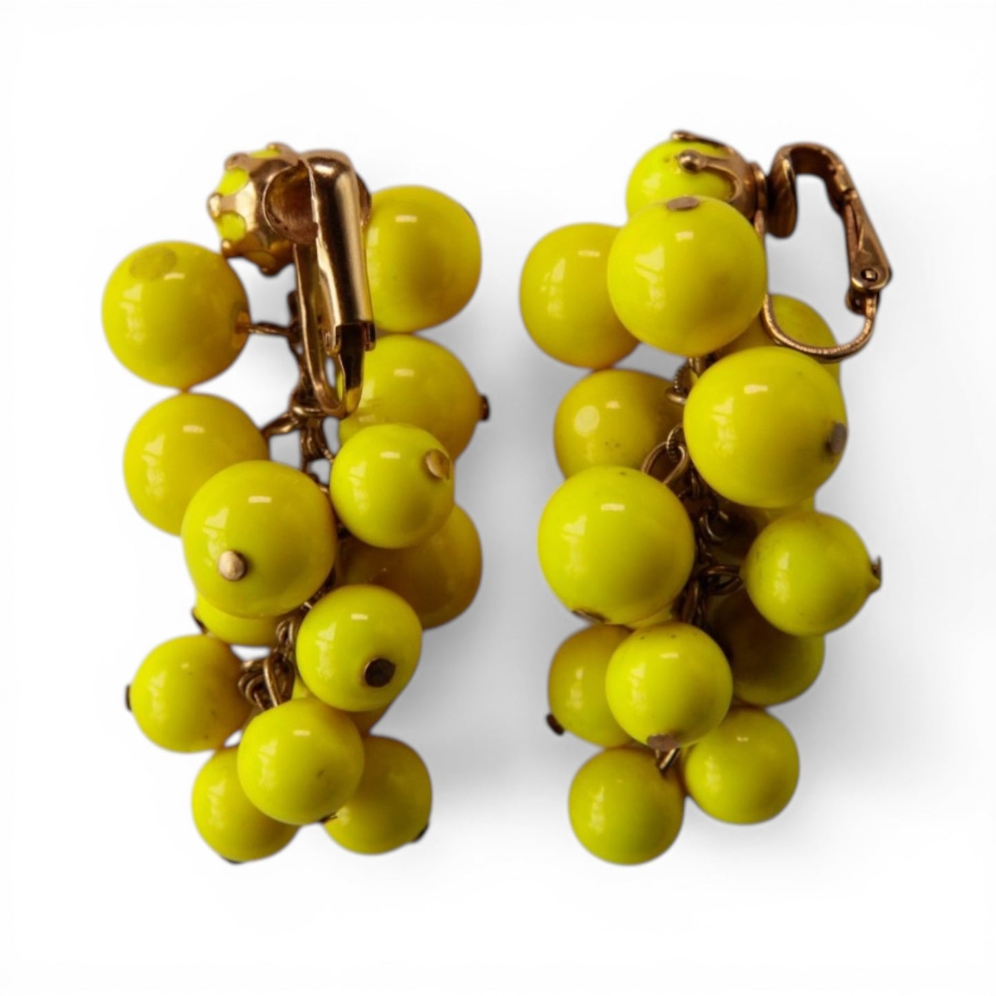 Reverse view of chartreuse glass bead cluster earrings showing gold-tone hinged clip-on fasteners and individual bead pin ...