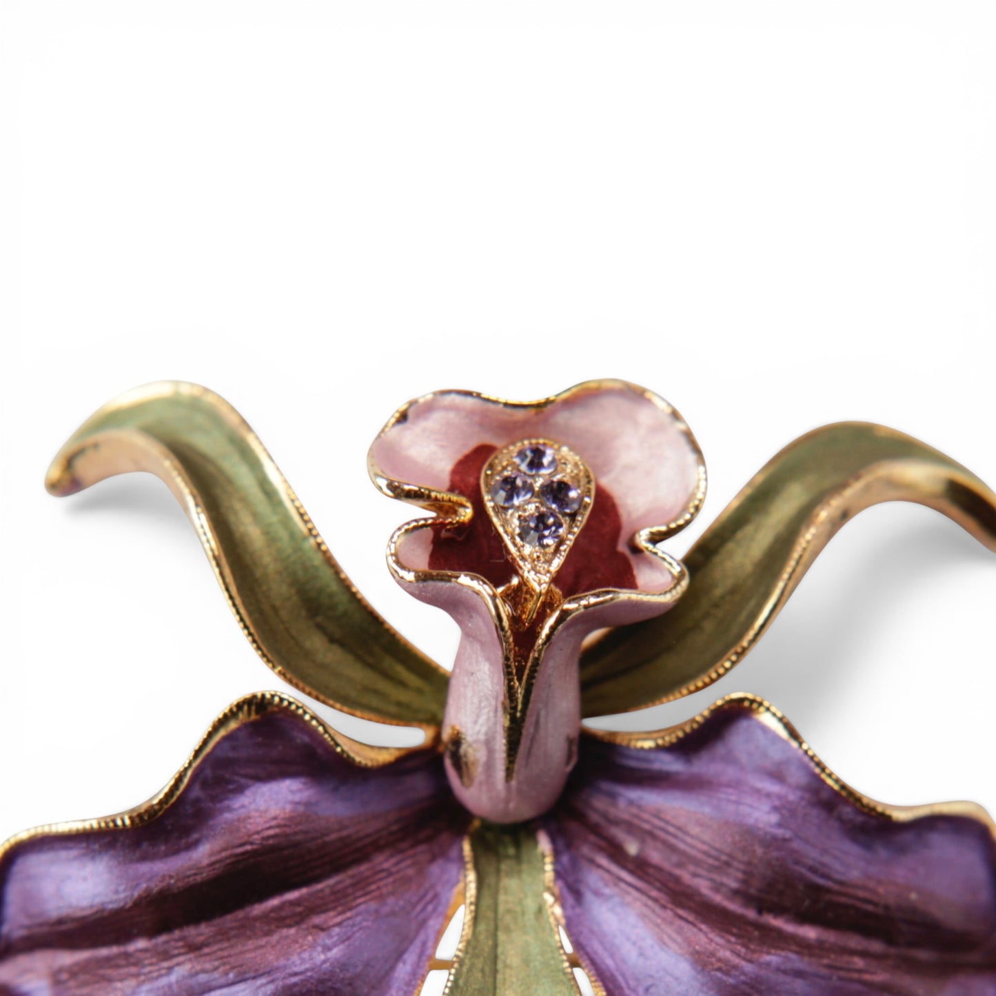 Close-up of orchid brooch centre column showing teardrop rhinestone setting with three prong-set clear stones against pink...