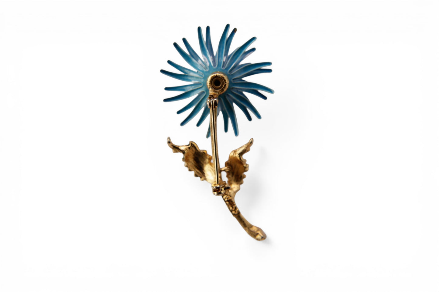 Gold-tone cast metal stem with bark texture detail and two scalloped green enamel leaves on floral brooch