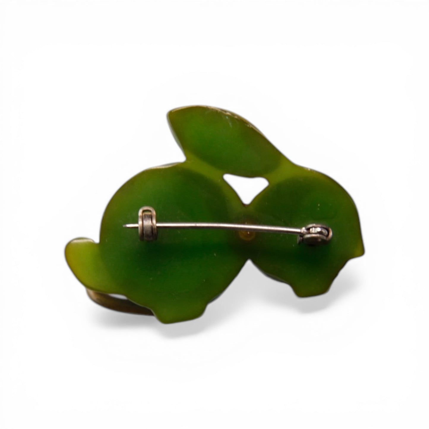 Reverse of Bakelite rabbit brooch showing flat green Bakelite backing plate and roller C-clasp silver-toned pin back