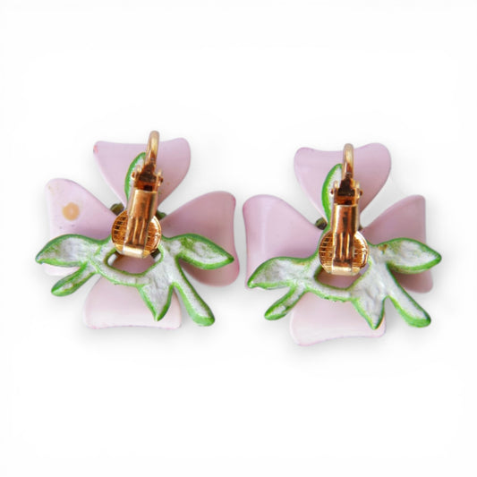 Reverse of pink enamel flower clip-on earrings showing gold-tone omega clip findings mounted on round gold-tone disc pads