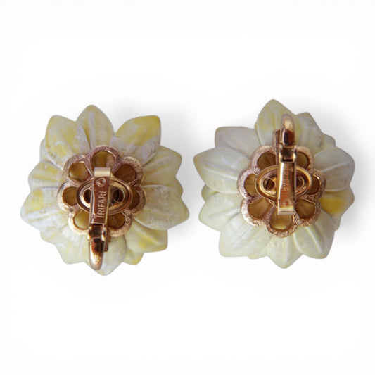 Reverse of TRIFARI clip-on earrings showing scalloped gold-tone back plate with TRIFARI copyright mark stamped on clip bar