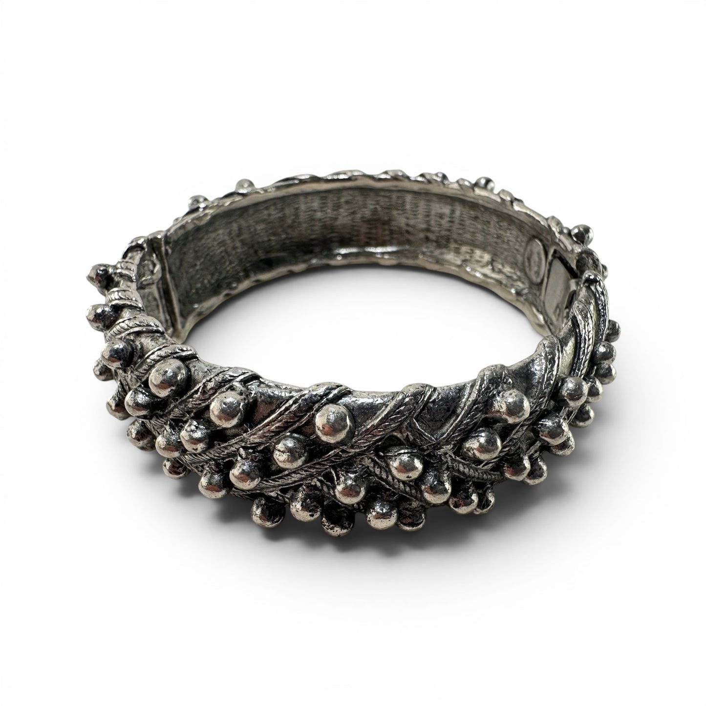 Wide silver-tone hinged cuff bangle by Hattie Carnegie with granulated ball-bead borders and twisted rope relief detailing...