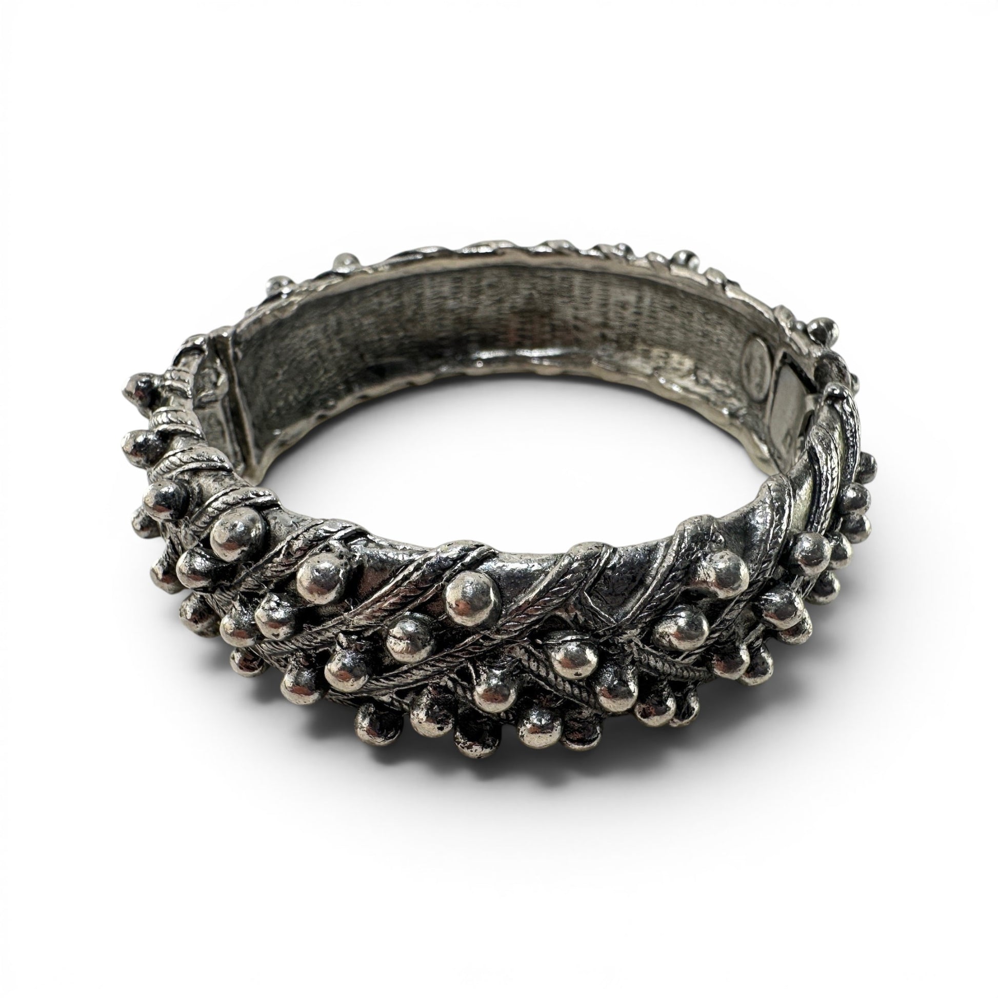 Wide silver-tone hinged cuff bangle by Hattie Carnegie with granulated ball-bead borders and twisted rope relief detailing...