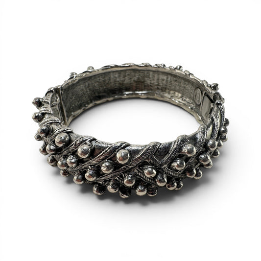 Wide silver-tone hinged cuff bangle by Hattie Carnegie with granulated ball-bead borders and twisted rope relief detailing...