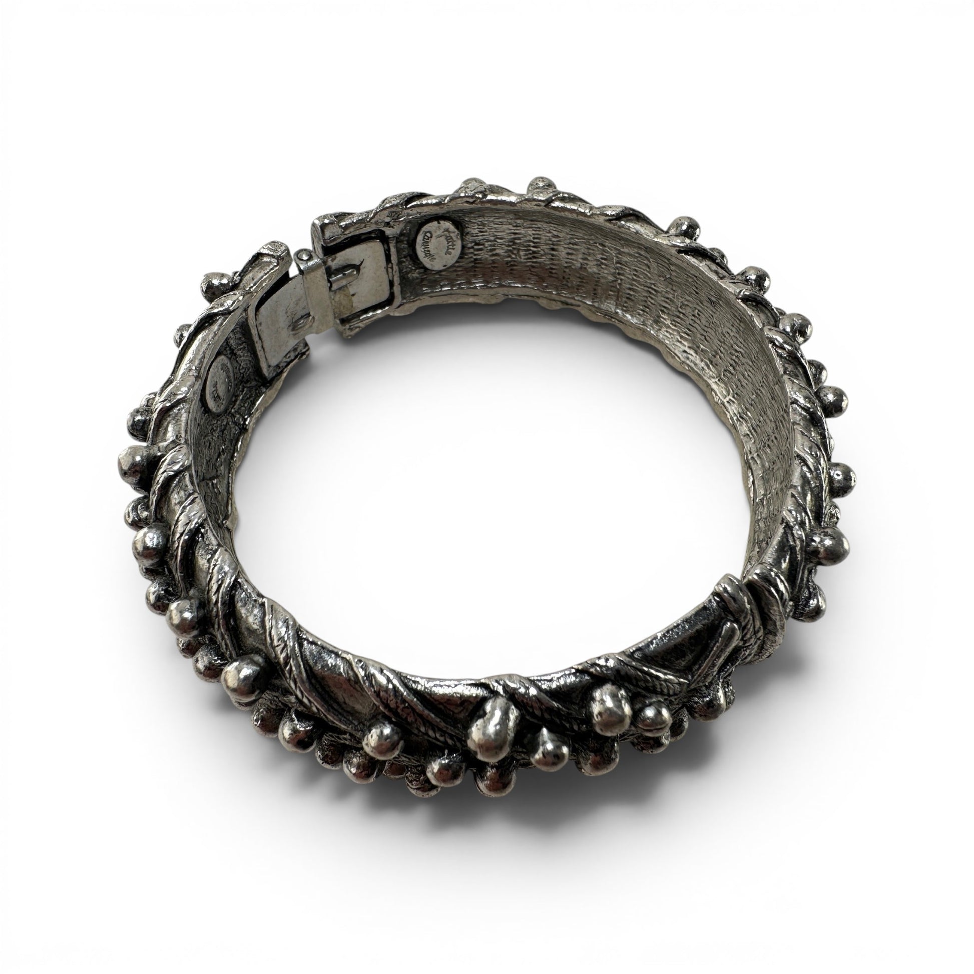 Close-up of box-clasp push-tab closure on silver-tone Hattie Carnegie cuff bangle with dark oxidation patina