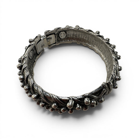 Close-up of box-clasp push-tab closure on silver-tone Hattie Carnegie cuff bangle with dark oxidation patina