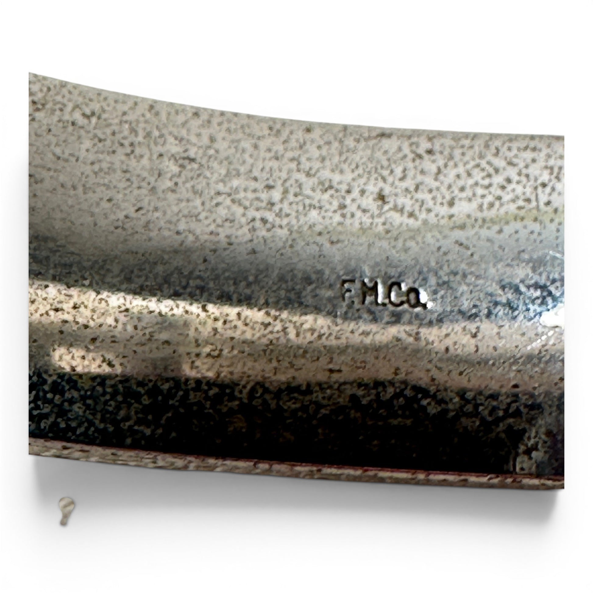 Side view of sterling silver bangle showing hinged construction, box clasp, and small safety chain at one side of the hinge