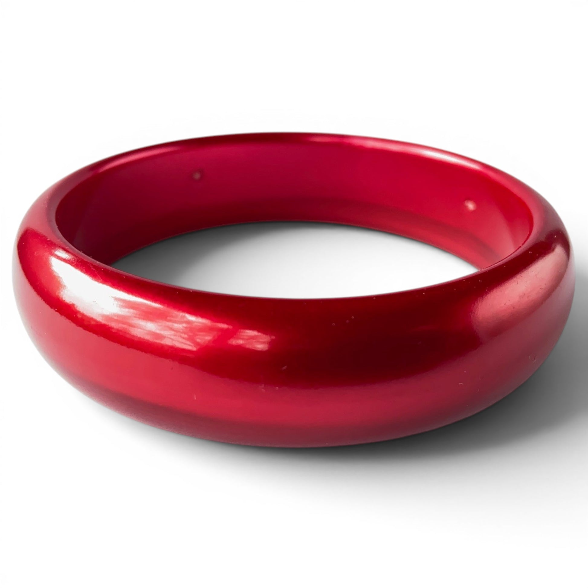 Art Deco deep crimson red Bakelite bangle bracelet with domed cross-section and high-gloss marbled surface, no clasp