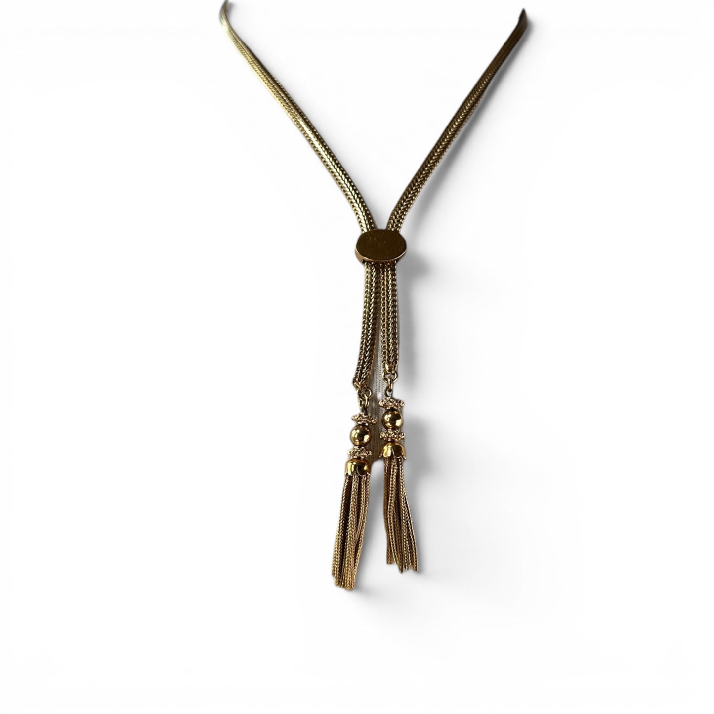 Gold-tone lariat necklace with wide foxtail chain, oval amber stone slider, and four tassel drops, displayed on a bust form