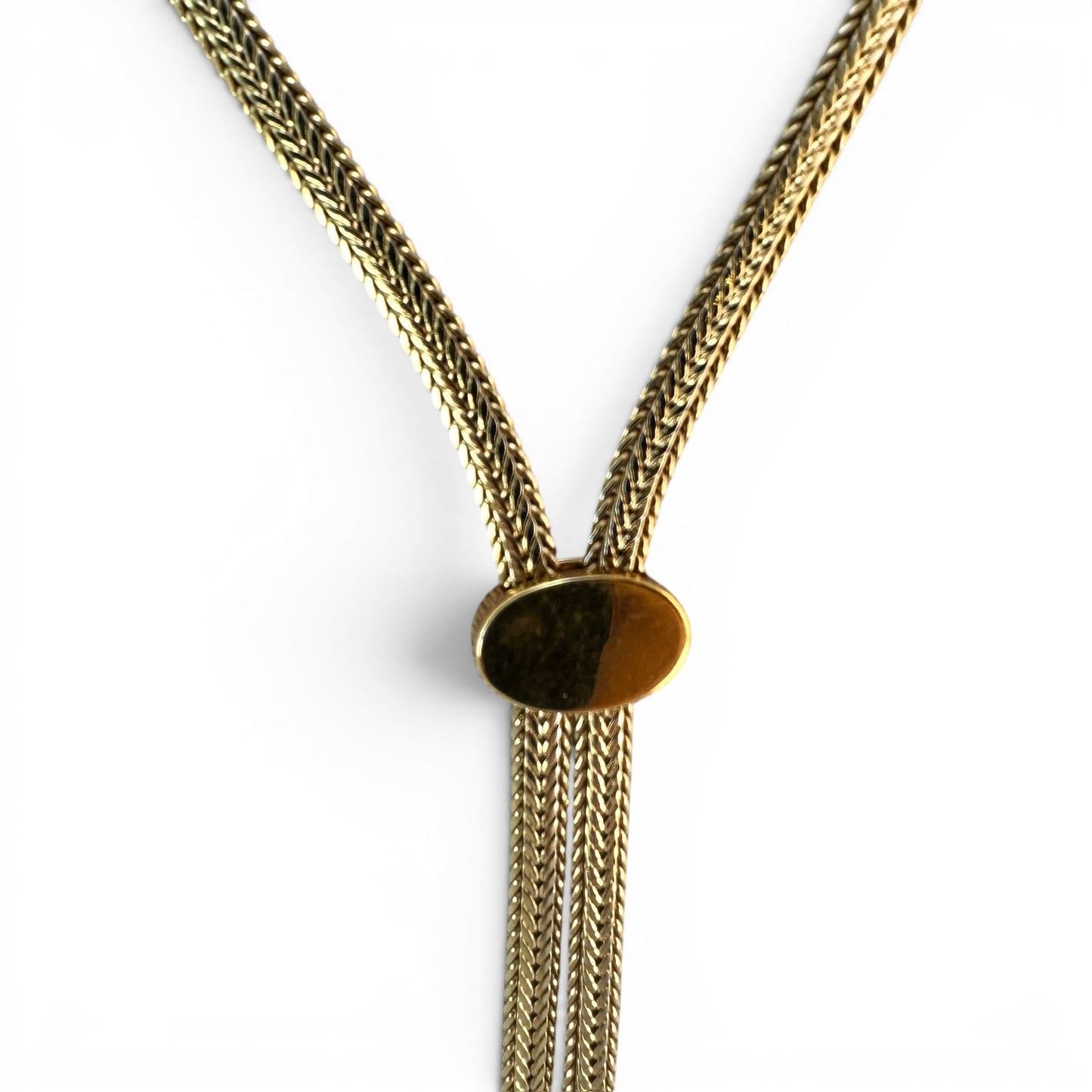 Close-up of oval slider bead set with a faceted amber cognac stone on a gold-tone foxtail chain