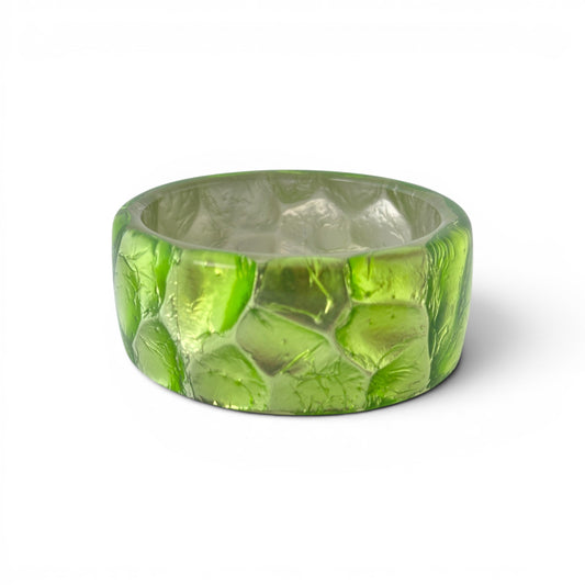 Wide clear Lucite bangle with crinkled lime green metallic foil inclusion, faceted exterior surface, circa 1960s–1970s, to...