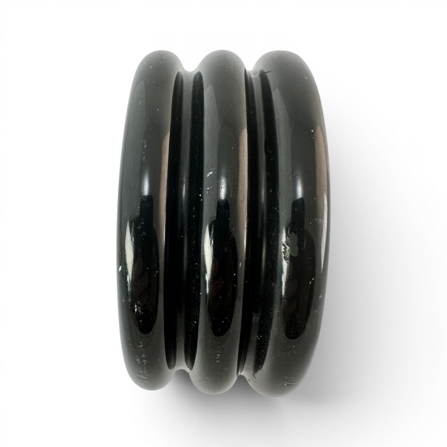 Side profile of wide black Bakelite bangle measuring approximately 1 5/8 inches wide with smooth cylindrical interior bore