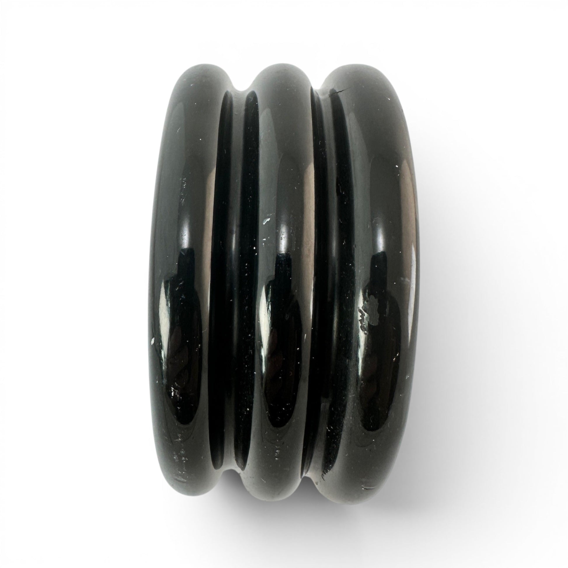 Side profile of wide black Bakelite bangle measuring approximately 1 5/8 inches wide with smooth cylindrical interior bore