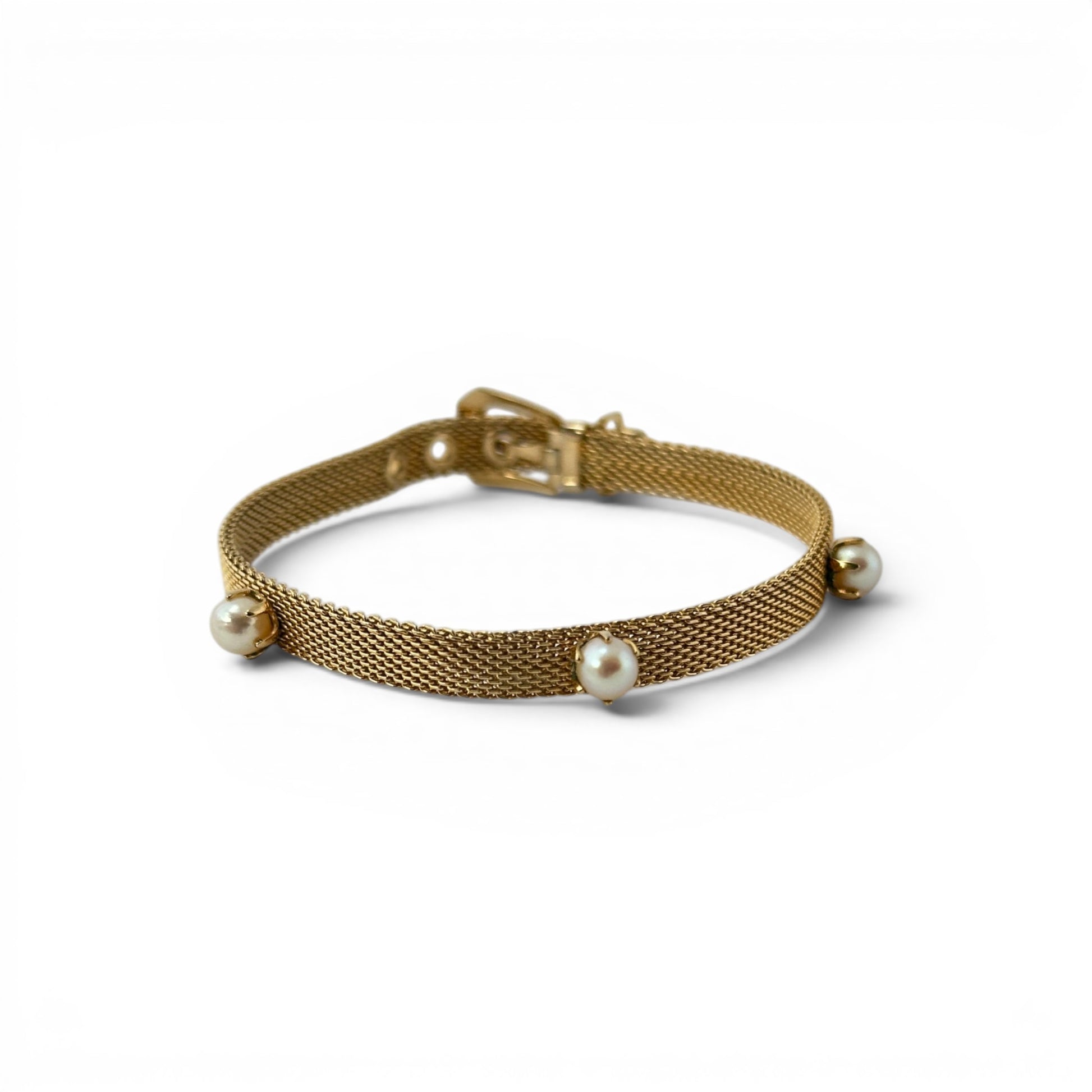 Gold flat mesh belt-buckle bracelet with three evenly spaced round cultured pearl stations in prong settings, laid flat