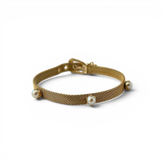 Gold flat mesh belt-buckle bracelet with three evenly spaced round cultured pearl stations in prong settings, laid flat