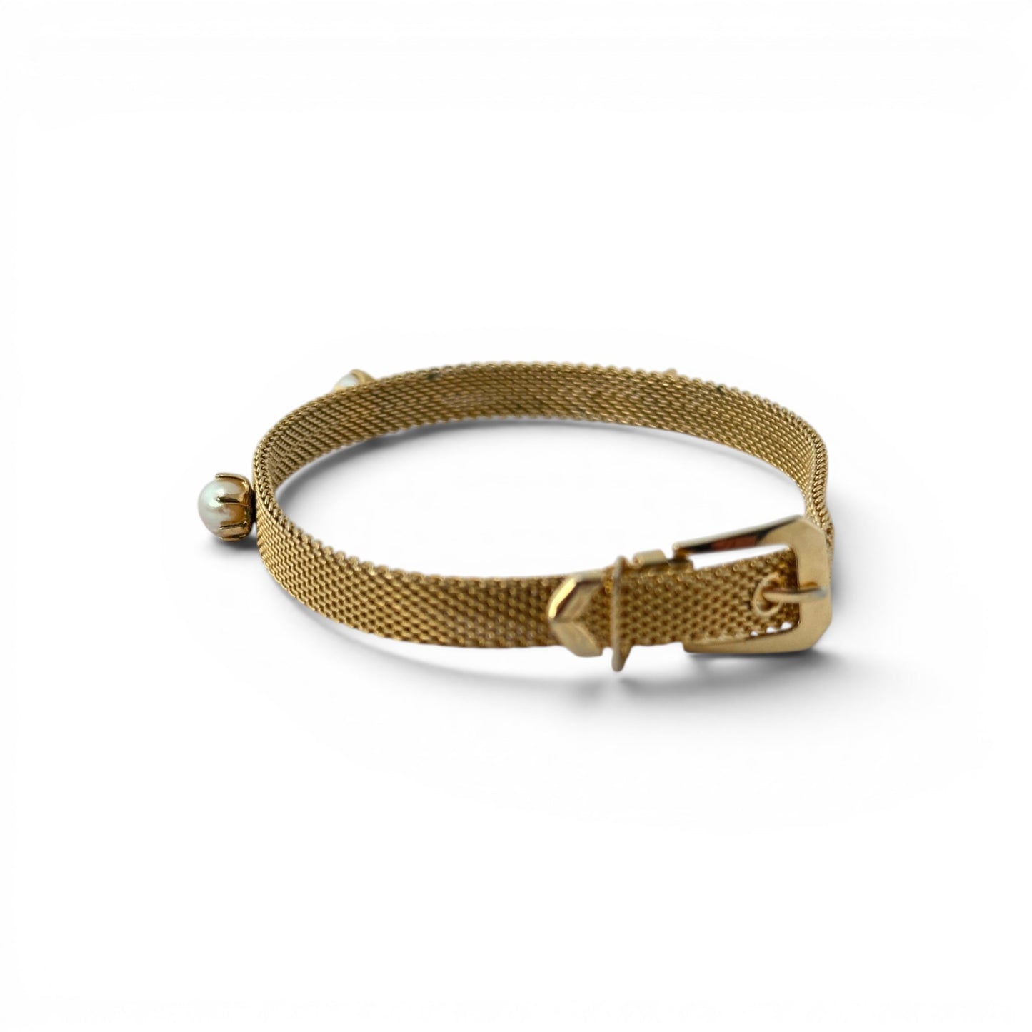 Gold mesh bracelet with belt buckle clasp showing central pin, keeper loop, and tapered punch-hole tail end with small sta...
