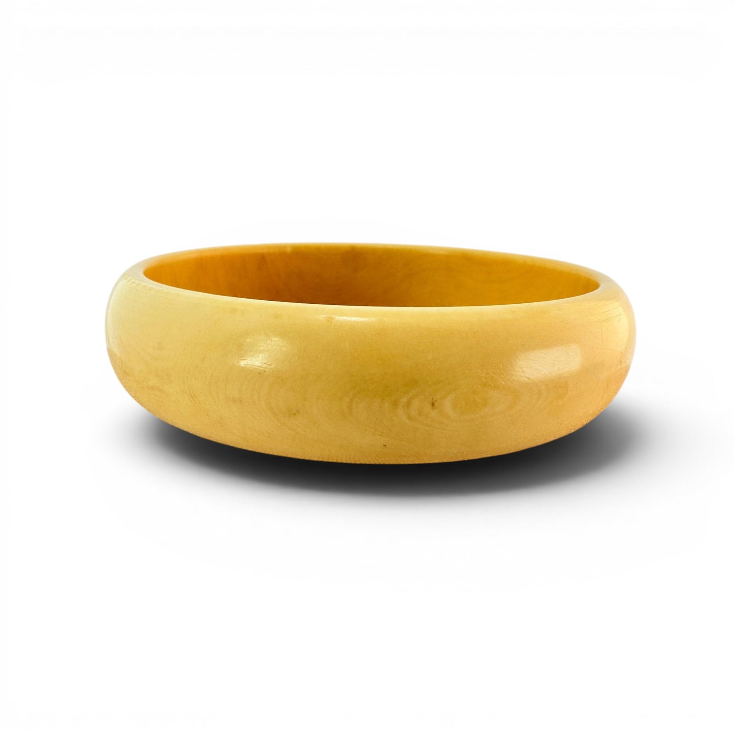 Wide domed butterscotch Bakelite bangle bracelet with high-gloss polished surface and swirling grain, MCM- Mid Century Modern era