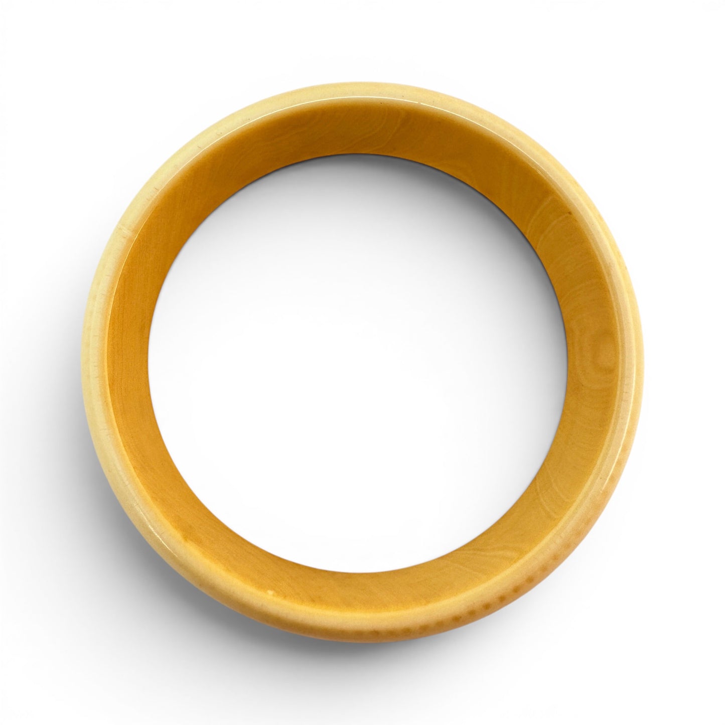 Side profile view of wide low-profile Bakelite bangle showing domed exterior and straight interior wall, no clasp or hinge
