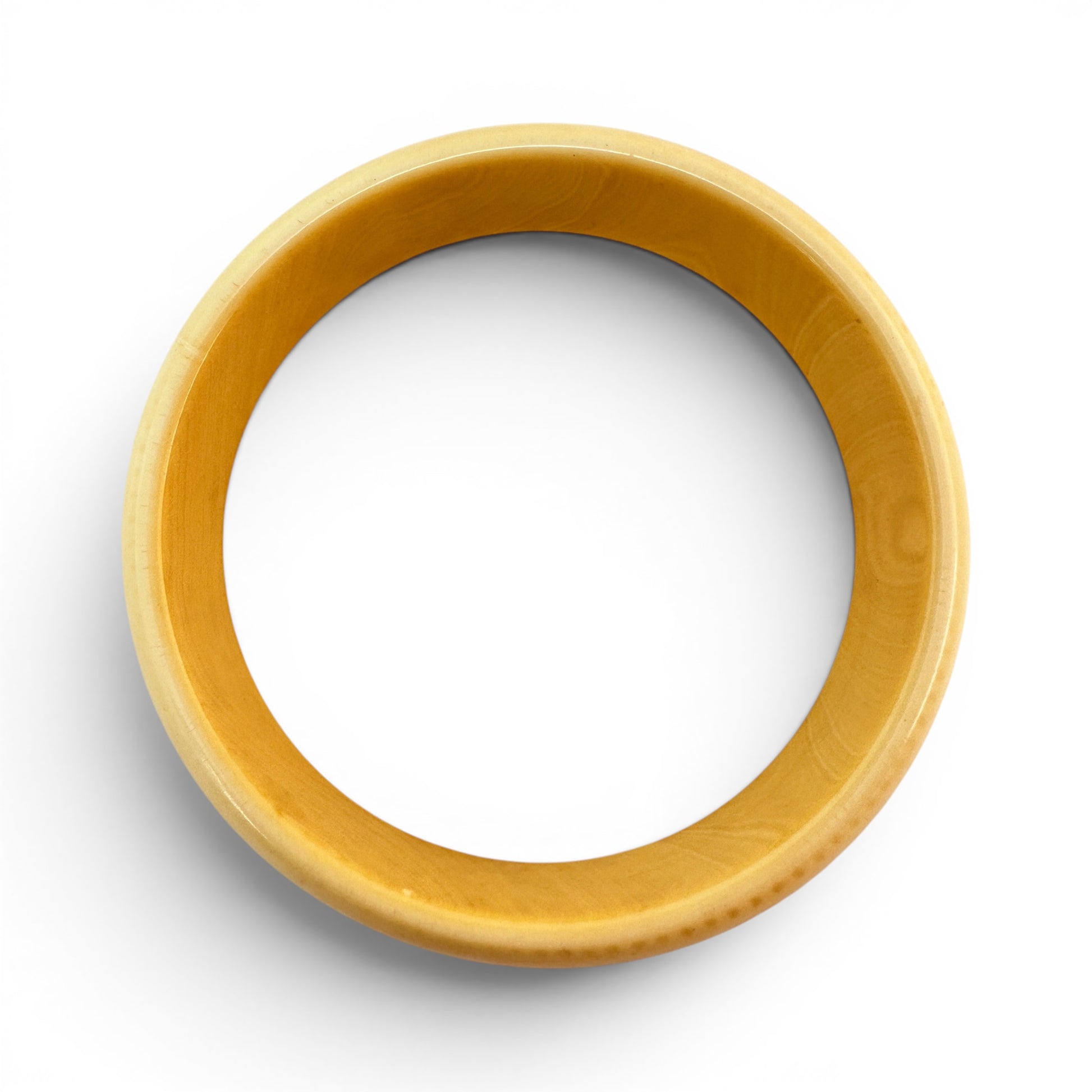 Side profile view of wide low-profile Bakelite bangle showing domed exterior and straight interior wall, no clasp or hinge