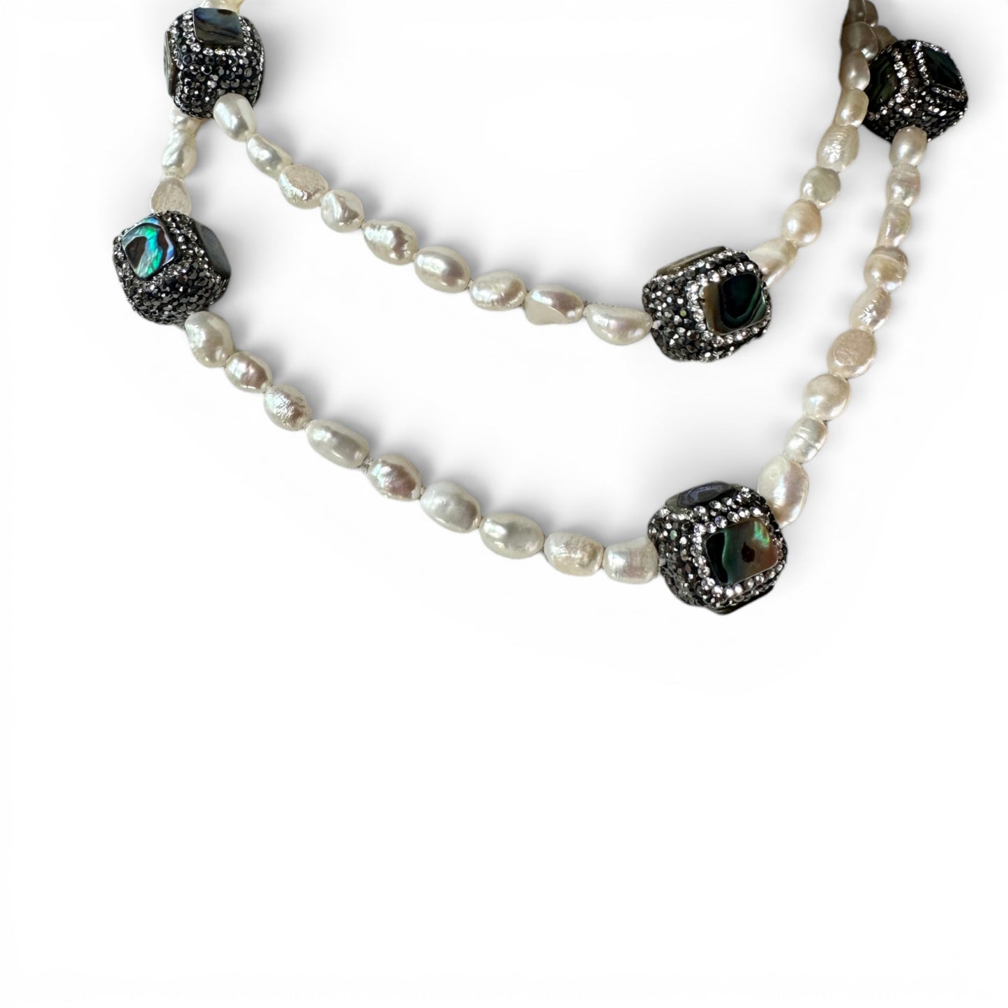 Full-length view of necklace worn as single strand showing irregular baroque pearl spacing and focal bead placement
