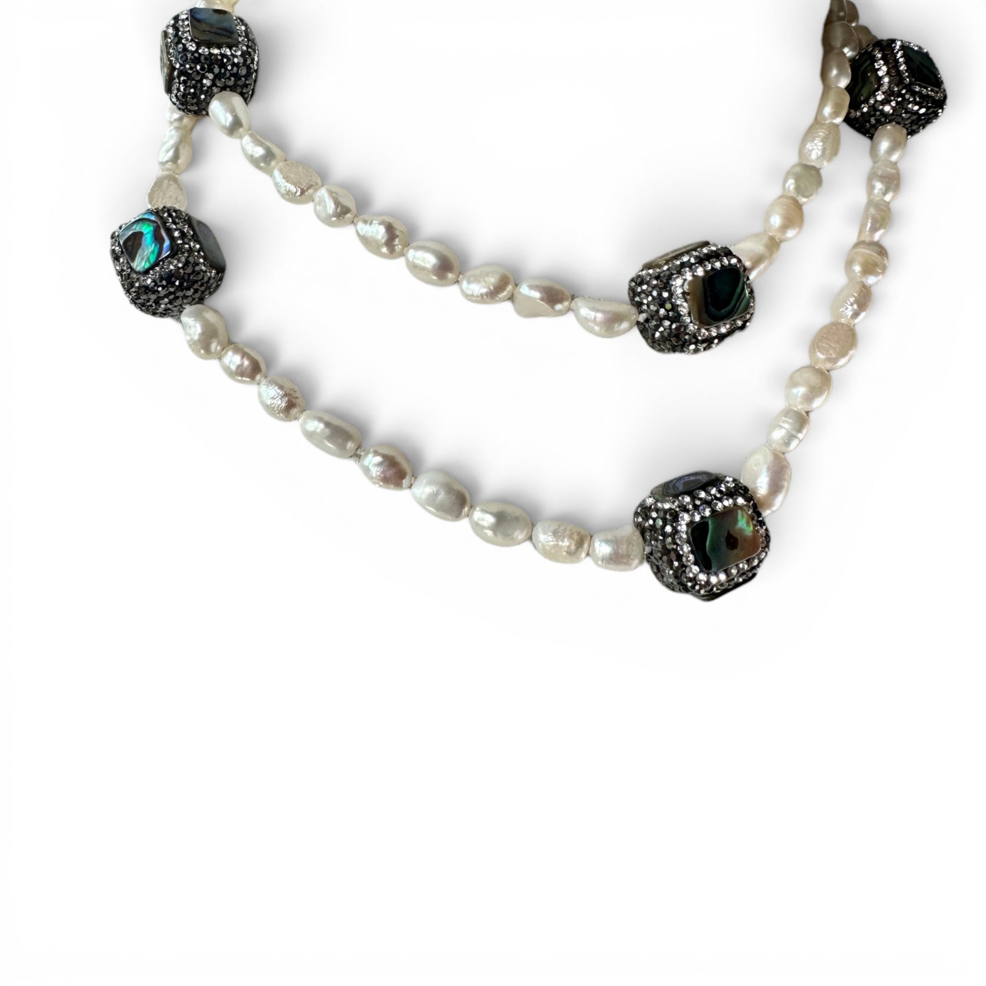 Full-length view of necklace worn as single strand showing irregular baroque pearl spacing and focal bead placement