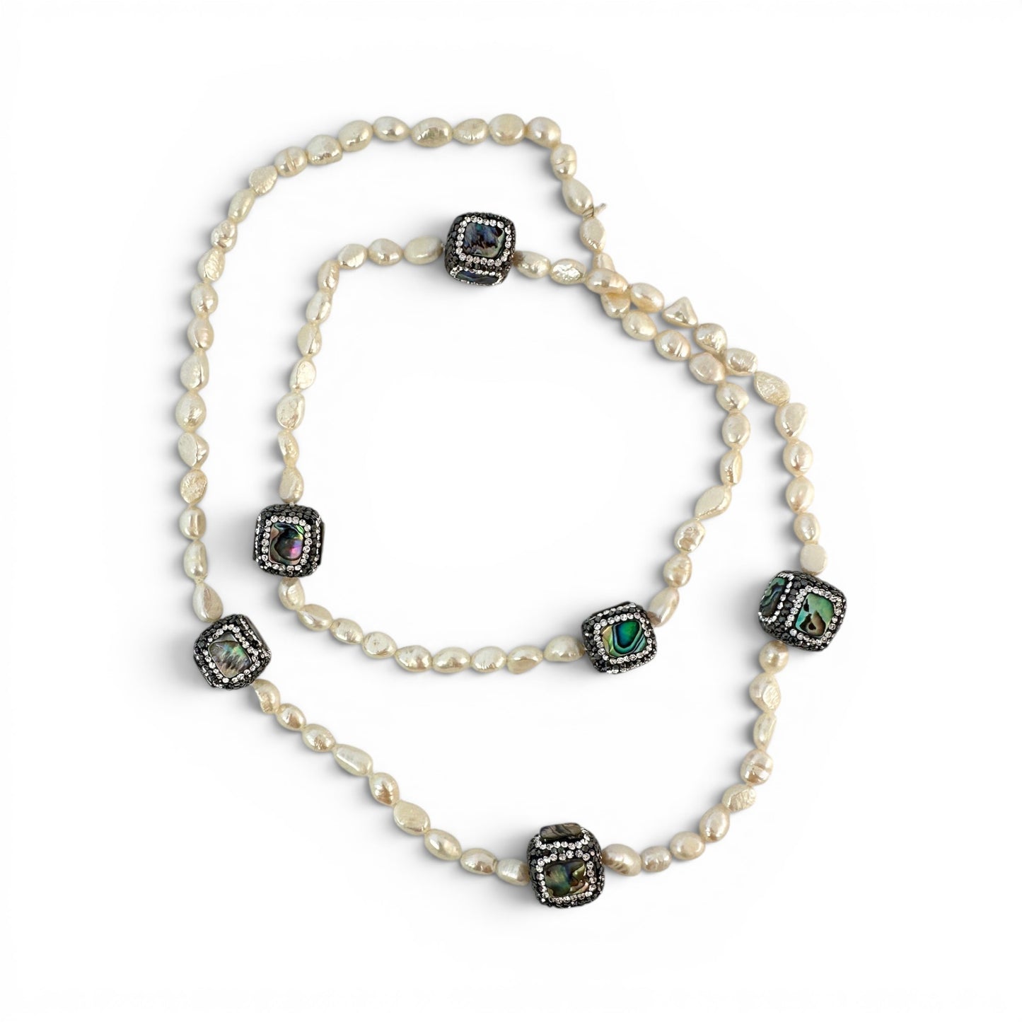 Flat lay of full 34-inch necklace displaying all six to seven focal beads and continuous baroque pearl strand