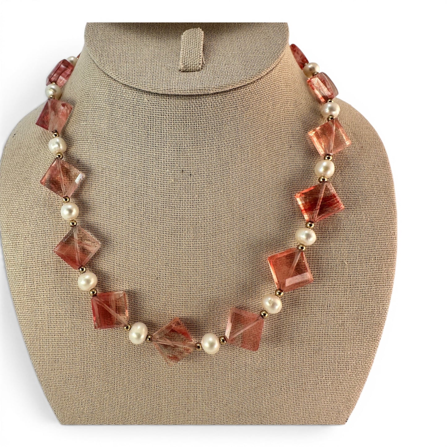 Beaded necklace with large faceted coral-red bicone glass stones alternating with round cream pearls and gold-tone spacer ...