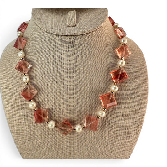 Beaded necklace with large faceted coral-red bicone glass stones alternating with round cream pearls and gold-tone spacer ...