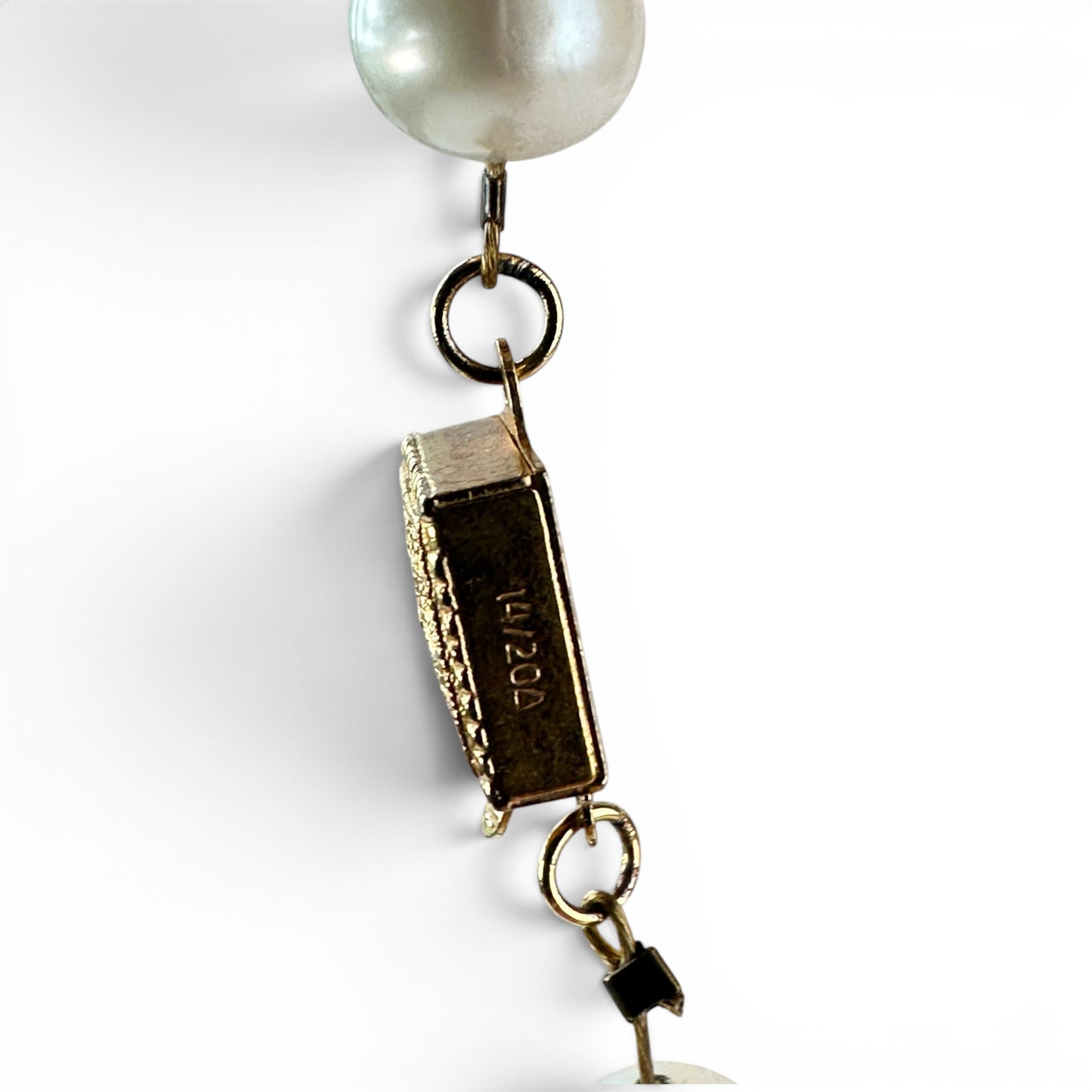 Full length of beaded necklace laid flat showing alternating pearl, faceted glass stone, and gold spacer bead pattern
